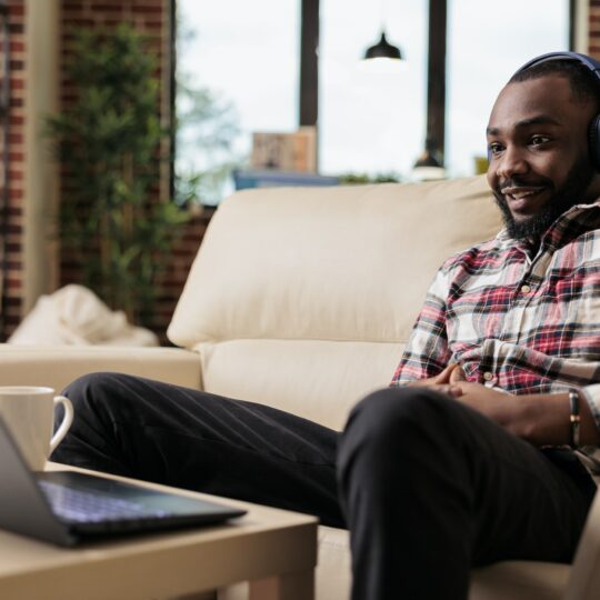 African american freelancer listening to music