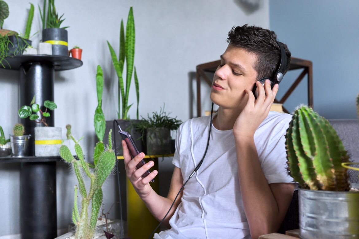 Portrait of teenage boy 16 years old in headphones listening to music