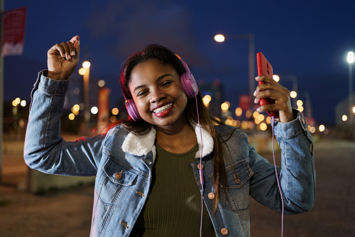 Young African American Latin Woman listening to salsa music on headphones